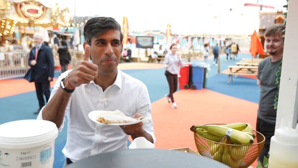 Britain’s Chancellor Rishi Sunak takes a pancake from a stall at the London Wonderground comedy and music festival venue in London - Sputnik International