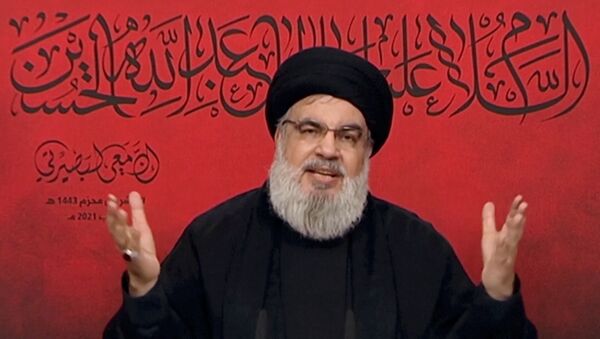 Lebanon's Hezbollah leader Sayyed Hassan Nasrallah speaks through a screen during a religious ceremony marking Ashura, in this screengrab taken from Al-Manar TV footage, Lebanon August 19, 2021. - Sputnik International