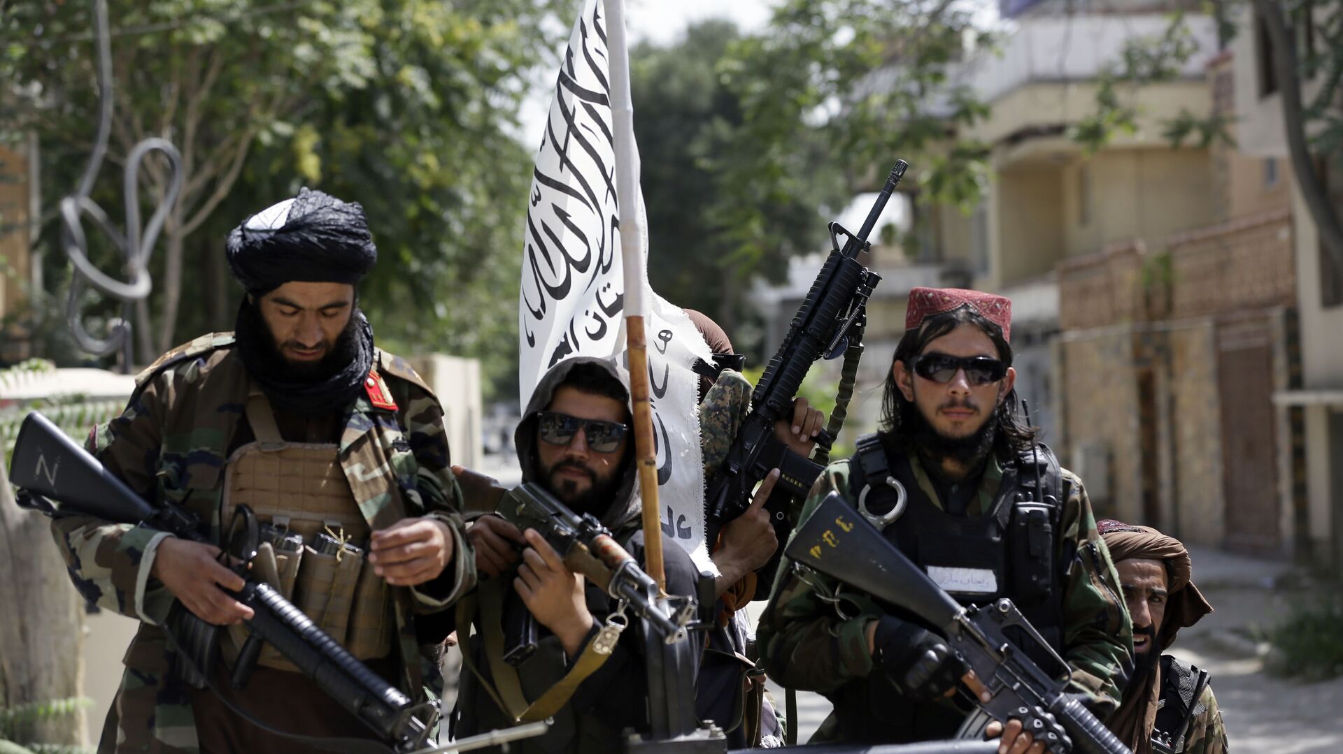 In this Aug. 19, 2021 file photo, Taliban fighters display their flag on patrol in Kabul, Afghanistan. When U.S. President Joe Biden took office early this year, Western allies were falling over themselves to welcome and praise him and hail a new era in trans-Atlantic cooperation. - Sputnik International, 1920, 27.08.2021