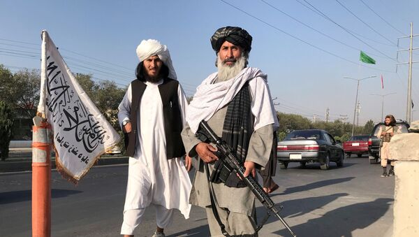 FILE PHOTO: A Taliban fighter holding an M16 assault rifle stands outside the Interior Ministry in Kabul, Afghanistan, August 16, 2021. - Sputnik International
