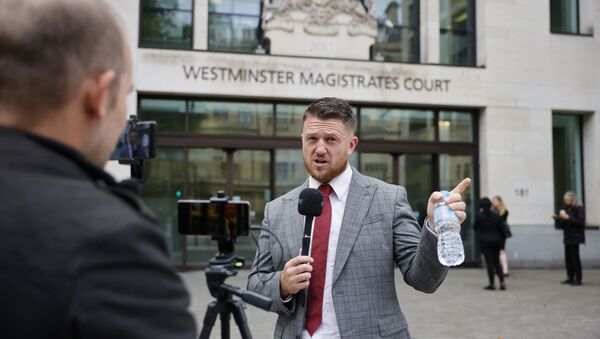 Founder and former leader of the anti-Islam English Defence League (EDL), Stephen Yaxley-Lennon, AKA Tommy Robinson, speaks to a camera as he arrives at Westminster Magistrates Court in central London on August 20, 2021 for a hearing after an application for a stalking protection order against him was filed.  - Sputnik International