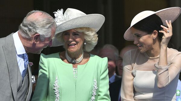 Britian's Prince Charles, left, reacts with Camilla, the Duchess of Cornwall and Meghan, the Duchess of Sussex, during a garden party at Buckingham Palace in London, Tuesday May 22, 2018. - Sputnik International