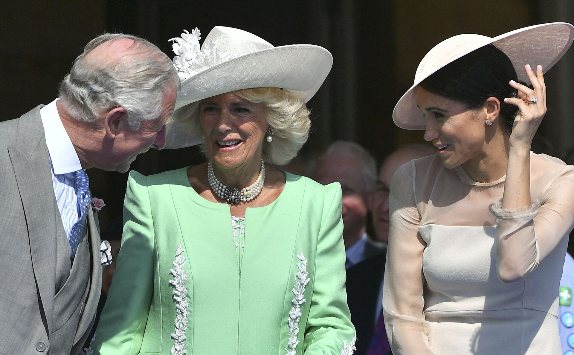 Britian's Prince Charles, left, reacts with Camilla, the Duchess of Cornwall and Meghan, the Duchess of Sussex, during a garden party at Buckingham Palace in London, Tuesday May 22, 2018. - Sputnik International, 1920, 07.09.2021