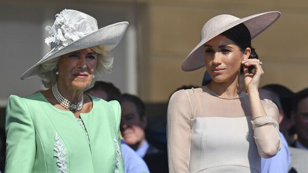 Meghan, the Duchess of Sussex, right, stands with Camilla, the Duchess of Cornwall, during a garden party at Buckingham Palace in London, Tuesday May 22, 2018. - Sputnik International