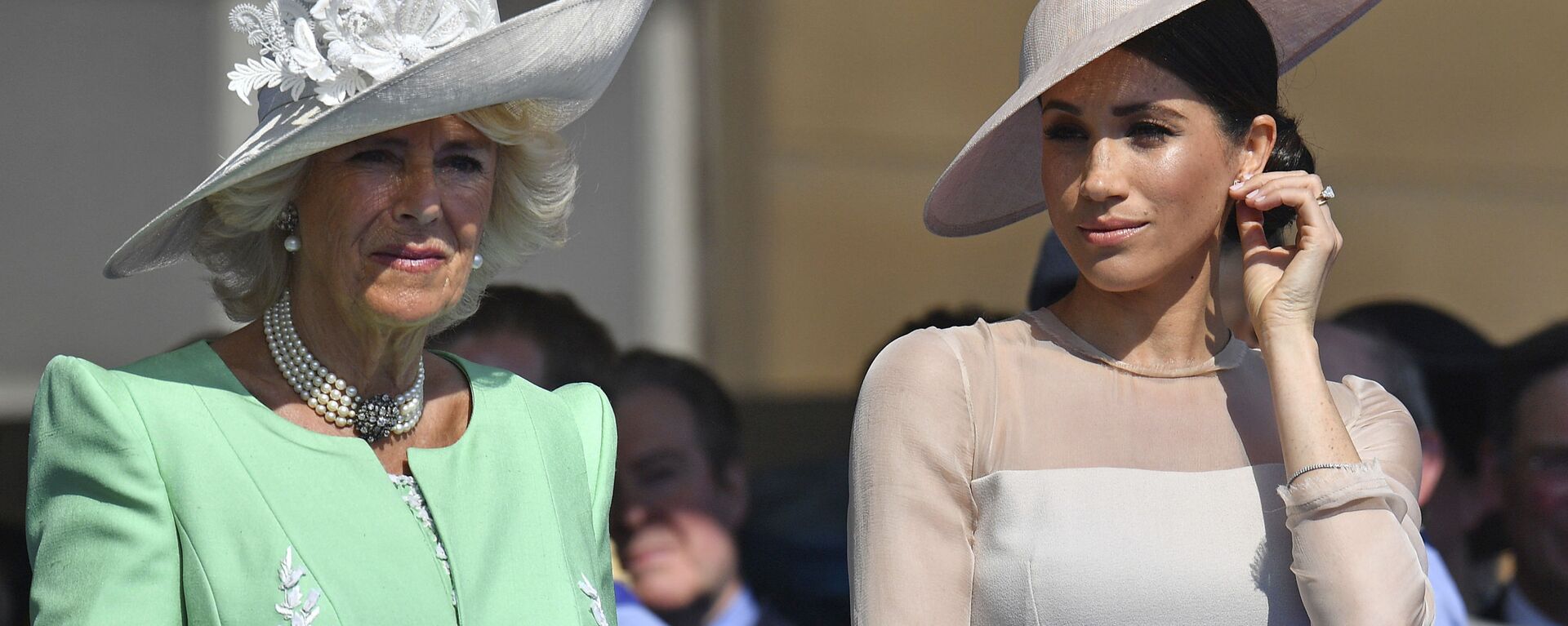 Meghan, the Duchess of Sussex, right, stands with Camilla, the Duchess of Cornwall, during a garden party at Buckingham Palace in London, Tuesday May 22, 2018. - Sputnik International, 1920, 22.07.2022