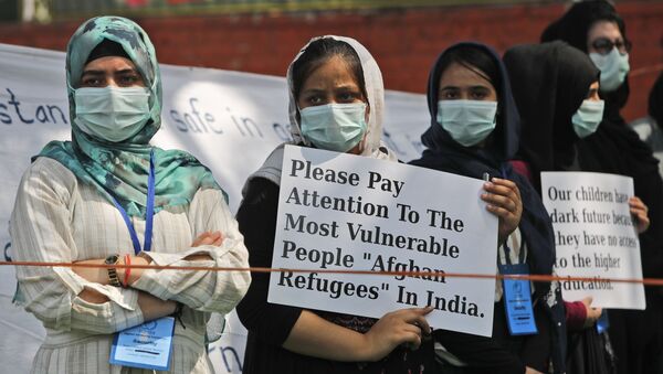 Afghanistan refugee women living in India hold placards during a demonstration to mark International Womens' Day in New Delhi, India, Monday, March 8, 2021.  - Sputnik International