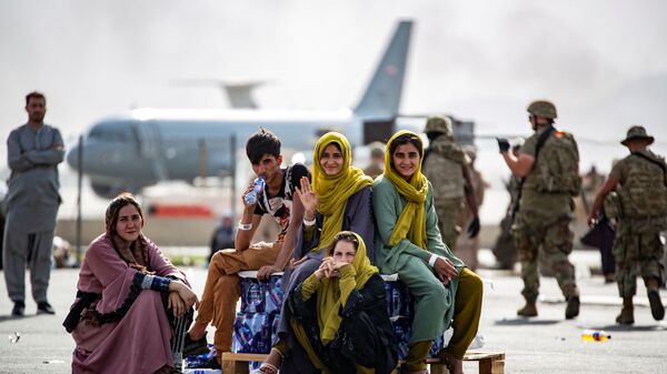 Evacuee children wait for the next flight after being manifested at Hamid Karzai International Airport, in Kabul, Afghanistan, August 19, 2021 - Sputnik International
