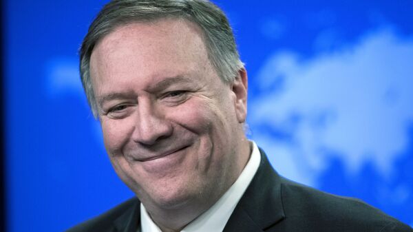 In this Nov. 26, 2019  file photo, then Secretary of State Mike Pompeo smiles as he speaks with reporters at the State Department in Washington. - Sputnik International