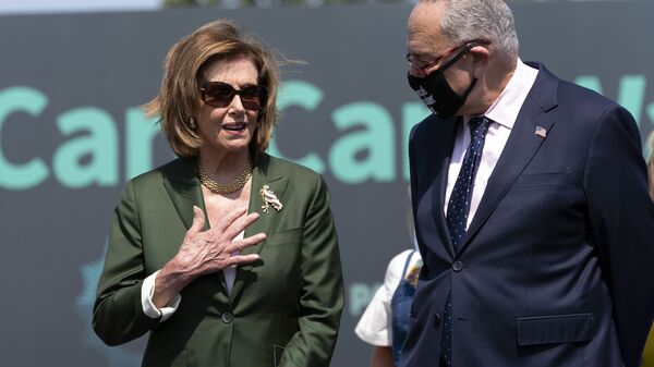 Speaker of the House Nancy Pelosi, D-Calif., speaks with Senate Majority Leader Chuck Schumer, D-N.Y., during Paid Leave for All rally on Capitol Hill in Washington, Wednesday, Aug. 4, 2021. - Sputnik International