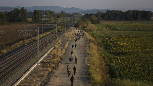 FILE - In this Thursday Aug. 27, 2015 file photo, migrants walk alongside railway tracks at Idomeni, northern Greece to cross the border and enter Macedonia. In the 28-nation EU, some countries have sought to block the unprecedented flow of migrants fleeing war or poverty in the Middle East and Africa. (AP Photo/Santi Palacios, File) - Sputnik International