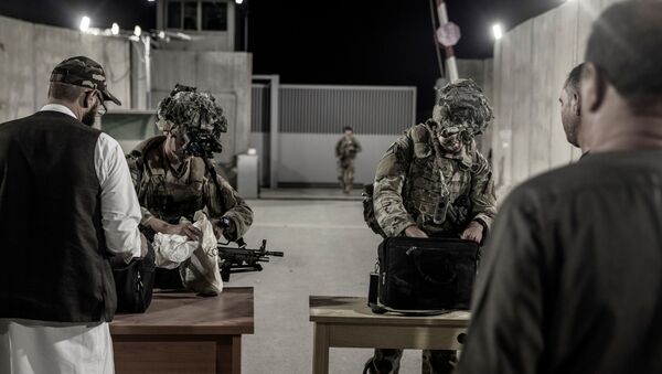 US Soliders with the 82nd Airborne Division check evacuees during an evacuation at Hamid Karzai International Airport in Kabul, Afghanistan, August 25, 2021. Picture taken August 25, 2021 - Sputnik International