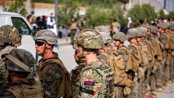 British Royal Marine Commandos and U.S. Marines assigned to the 24th Marine Expeditionary Unit work at an Evacuation Control Center (ECC) during an evacuation at Hamid Karzai International Airport, Kabul, Afghanistan, August 18, 2021 - Sputnik International