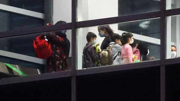 Women and children wait for a document check after disembarking from the last plane arriving with Afghan refugees via Tashkent at the airport in Frankfurt, Germany, August 27, 2021 - Sputnik International