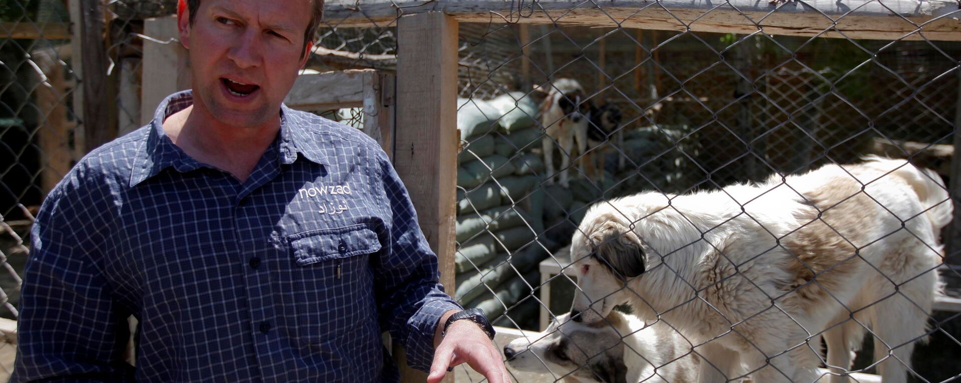 Pen Farthing, founder of British charity Nowzad, an animal shelter, stands in front of a cage on the outskirts of Kabul May 1, 2012. A former Royal Marine, Farthing adopted his dog Nowzad, named after a Helmand district, during his tour there in 2006. He then set up the charity, where dogs and some cats are neutered and vaccinated against rabies before their journeys abroad. Nowzad has given homes to over 330 dogs since it was founded, mostly to soldiers from the U.S. and Britain, but also from South Africa, Australia, Canada and the Netherlands. Picture taken May 1, 2012. - Sputnik International, 1920, 29.08.2021