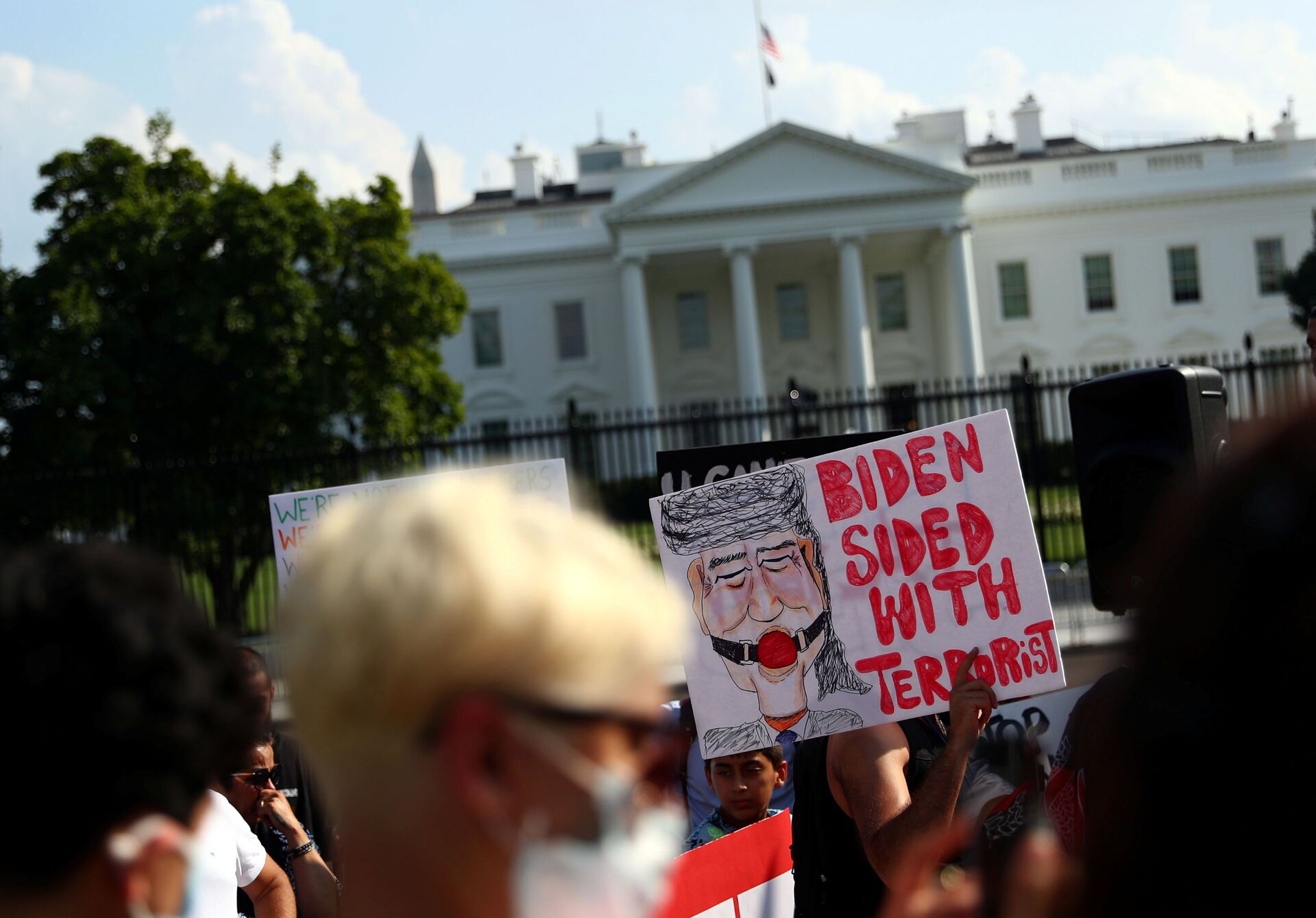 A protestor holds a placard during a demonstration challenging the transparency of the evacuation process from Kabul Airport, at Lafayette park near the White House in Washington, U.S., August 28, 2021. REUTERS/Tom Brenner - Sputnik International, 1920, 07.09.2021