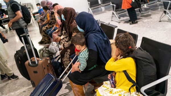 Refugees from Afghanistan wait to be processed after arriving on an evacuation flight at Heathrow Airport, in London, Britain August 26, 2021 - Sputnik International