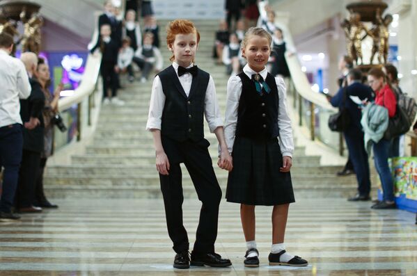 Children pose for a photo wearing classical school uniforms in Moscow, Russia.  - Sputnik International
