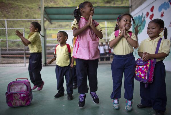Children jump and smile during an activity at a school in Caracas, Venezuela.  - Sputnik International