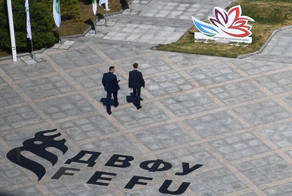 Men seen on the campus of the Far Eastern Federal University on Russky Island ahead of the Eastern Economic Forum on 2-4 September. - Sputnik International