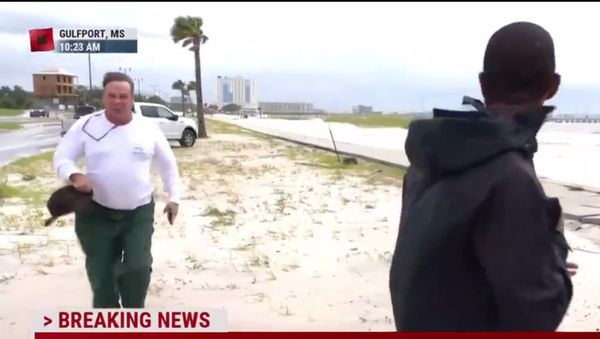 A screenshot from TV coverage showing Dagley running toward MSNBC reporter Shaquille Brewster on August 30, 2021 - Sputnik International