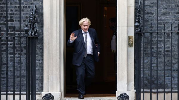 Britain's Prime Minister Boris Johnson waves as he walks on Downing Street in London, Britain, August 24, 2021. - Sputnik International