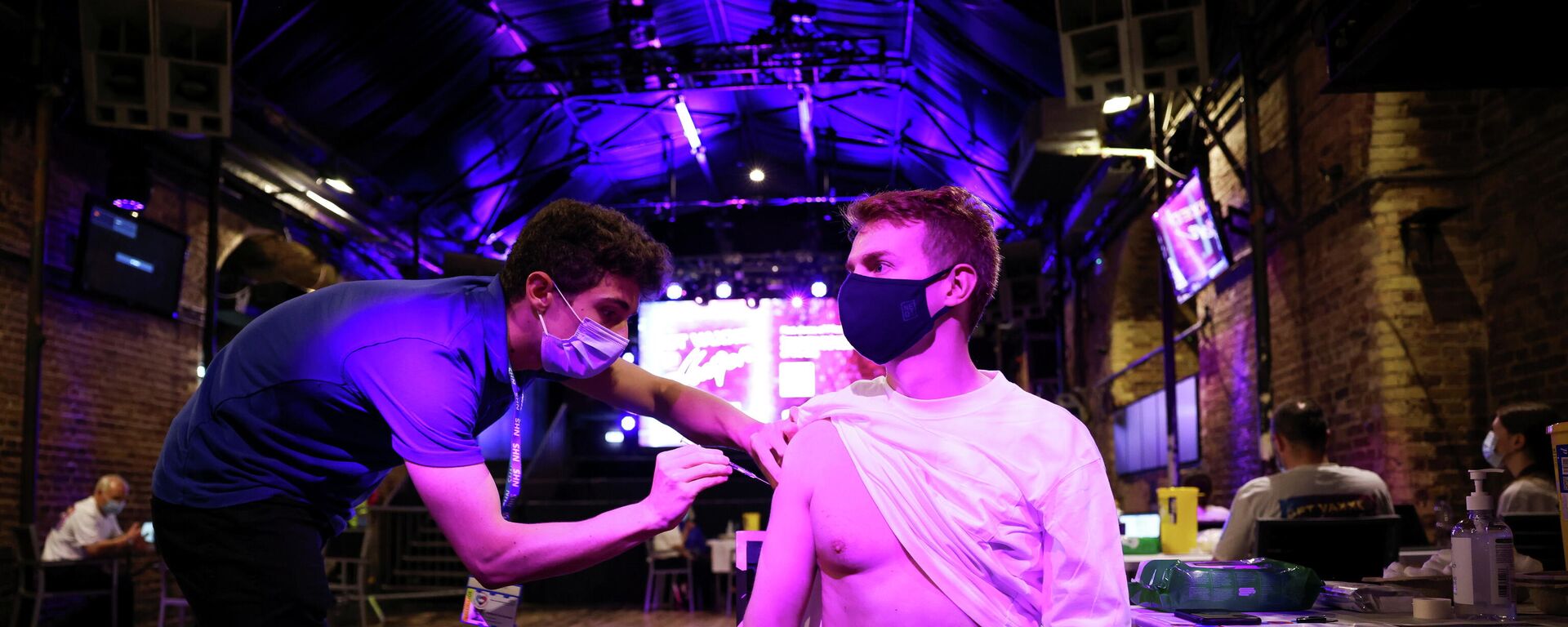 A person receives a dose of the Pfizer BioNTech vaccine at an NHS vaccination centre hosted at the Heaven nightclub, amid the coronavirus disease (COVID-19) pandemic, in London, Britain, August 8, 2021 A person receives a dose of the Pfizer BioNTech vaccine at an NHS vaccination centre hosted at the Heaven nightclub, amid the coronavirus disease (COVID-19) pandemic, in London, Britain, August 8, 2021 - Sputnik International, 1920, 07.09.2021
