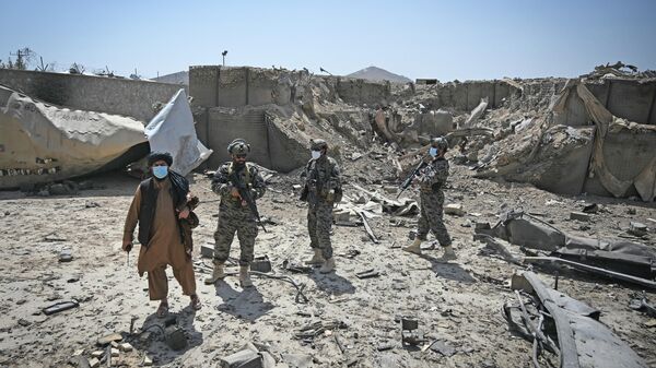 Members of the Taliban Badri 313 military unit stand besides ammunition lying on the ground amid the debris of the destroyed Central Intelligence Agency (CIA) base in Deh Sabz district northeast of Kabul on September 6, 2021 after the US pulled all its troops out of the country - Sputnik International