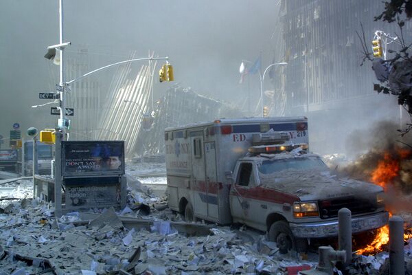 An ambulance, covered with debris, is on fire after the collapse of the first World Trade Center Tower on 11 September, 2001 in New York. - Sputnik International