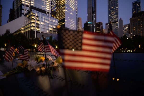 US flags are displayed before a reflecting pool at the 9/11 memorial commemorating the 2001 terrorist attacks, in New York on 10 September 2021. - Sputnik International