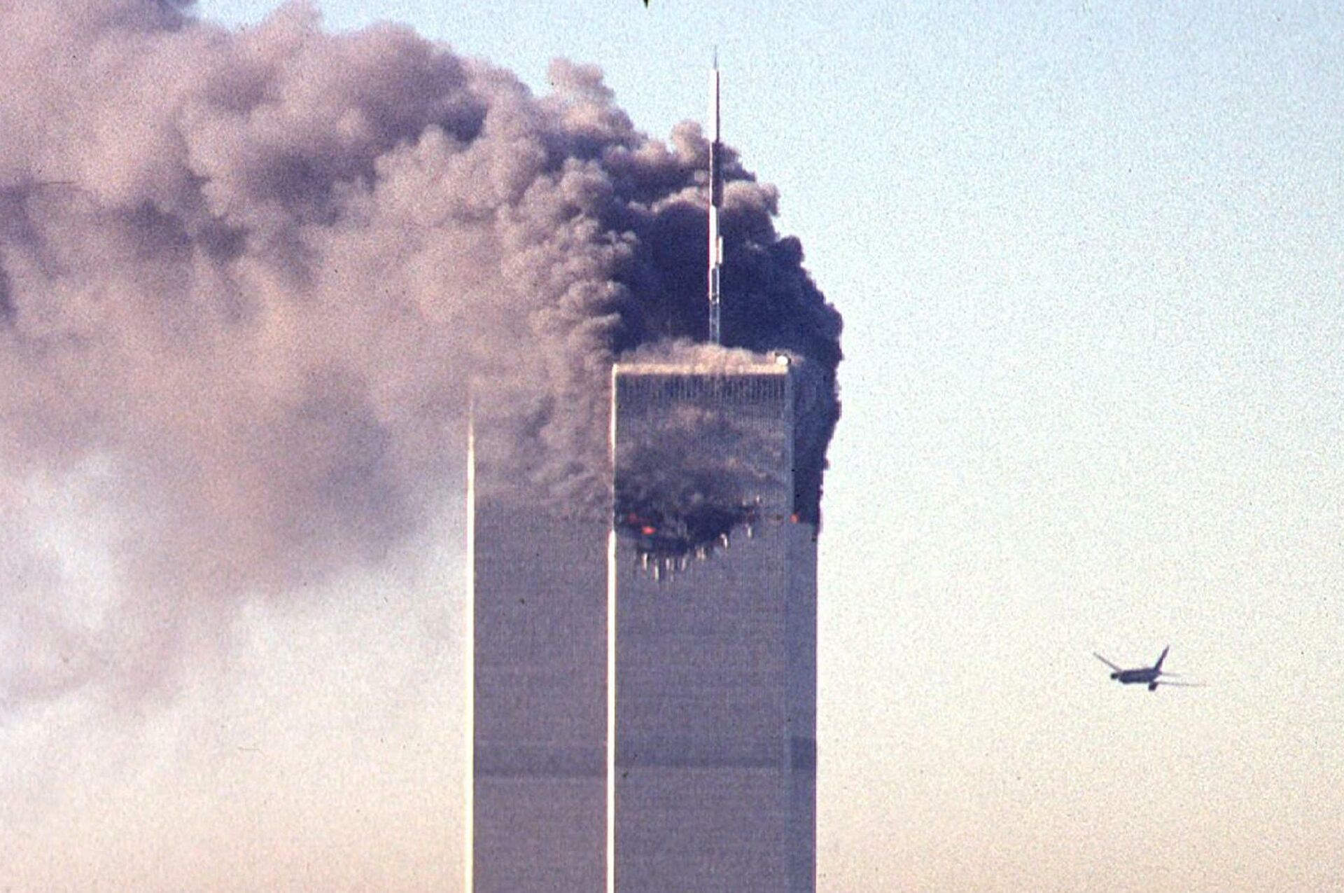 (FILES) In this file photo taken on September 11, 2001, a hijacked commercial aircraft approaches the twin towers of the World Trade Center shortly before crashing into the landmark skyscraper in New York.  - Sputnik International, 1920, 17.09.2021