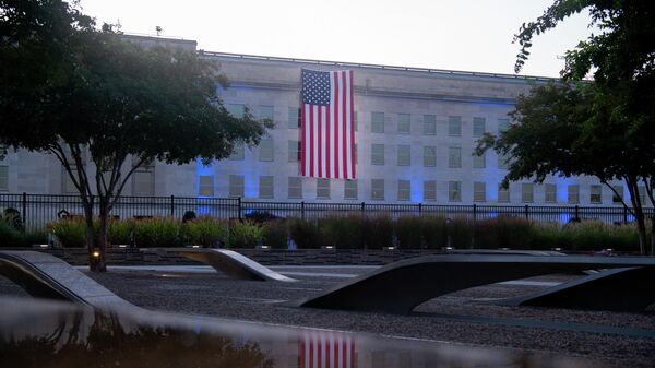 An American flag hangs from the side of the Pentagon to commemorate the 20th anniversary of the 9/11 attacks,as seen from the Pentagon 9/11 Memorial on September 11, 2021, in Washington,DC. - Sputnik International