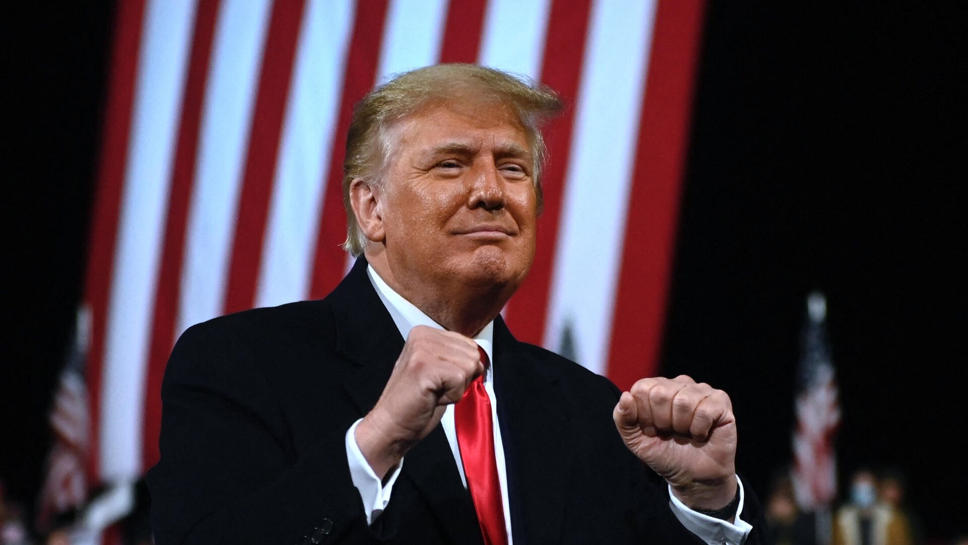 In this file photo taken on December 05, 2020 US President Donald Trump holds up his fists at the end of a rally to support Republican Senate candidates at Valdosta Regional Airport in Valdosta, Georgia. - Sputnik International, 1920, 11.09.2021