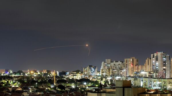 Streaks of light are seen as Israel's Iron Dome anti-missile system intercepts a rocket launched from the Gaza Strip towards Israel, as seen from Ashkelon, Israel September 11, 2021 - Sputnik International
