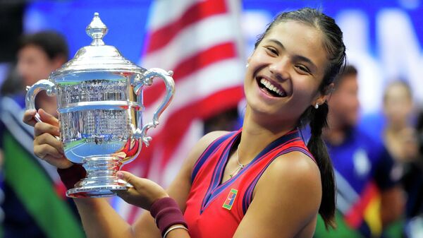 Emma Raducanu of Great Britain celebrates with the championship trophy after her match against Leylah Fernandez of Canada (not pictured) in the women's singles final on day thirteen of the 2021 U.S. Open tennis tournament at USTA Billie Jean King National Tennis Center. - Sputnik International