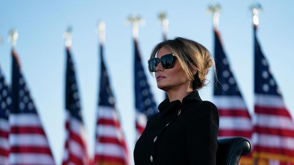 Melania Trump listens as her husband Outgoing US President Donald Trump addresses guests at Joint Base Andrews in Maryland on January 20, 2021 - Sputnik International