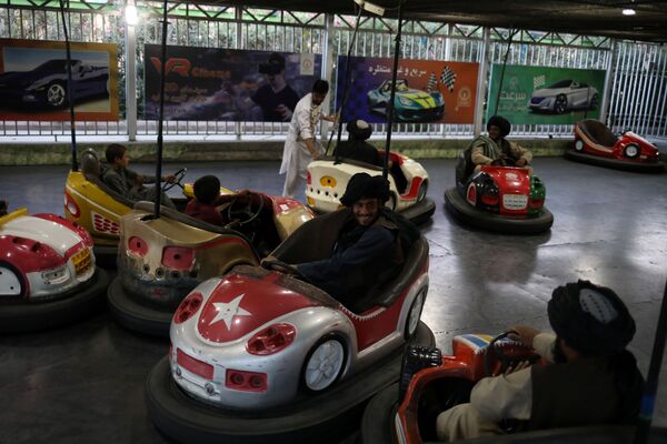 Taliban soldiers ride bumper cars in an amusement park in Kabul, Afghanistan, 13 September 2021.  - Sputnik International