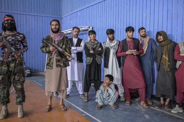 Taliban fighters stand as youths (not pictured) show their skills during an event organised for the visit of the Taliban&#x27;s director of physical education and sports, Bashir Ahmad Rustamzai (not pictured), at a gymnasium in Kabul on 14 September 2021. - Sputnik International