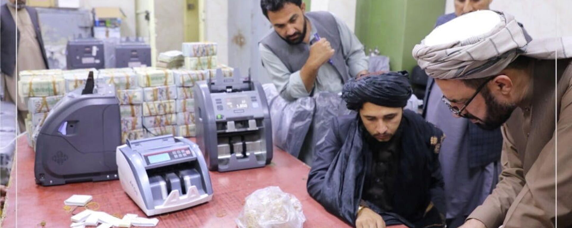 Men are pictured as Afghanistan's Taliban-controlled central bank seizes a large amount of money in cash and gold from former top government officials, including former vice president Amrullah Saleh, in Afghanistan, in this handout obtained by Reuters on September 15, 2021 - Sputnik International, 1920, 24.09.2021