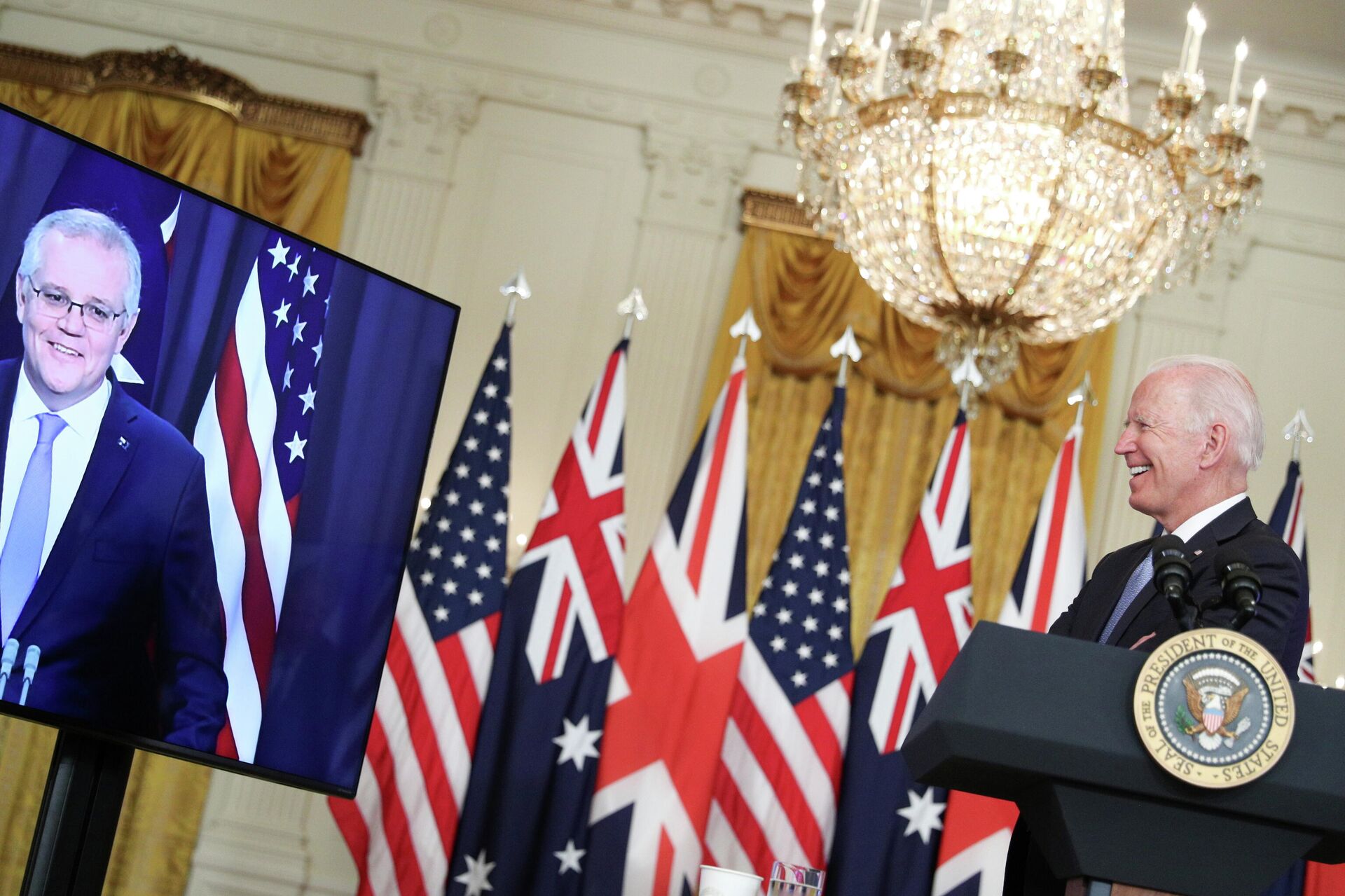 U.S. President Joe Biden smiles while delivering remarks on a National Security Initiative virtually with Australian Prime Minister Scott Morrison and British Prime Minister Boris Johnson (not pictured) inside the East Room at the White House in Washington, U.S., September 15, 2021 - Sputnik International, 1920, 16.09.2021
