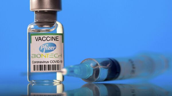 A vial labelled with the Pfizer-BioNTech coronavirus disease (COVID-19) vaccine is seen in this illustration picture taken March 19, 2021. - Sputnik International