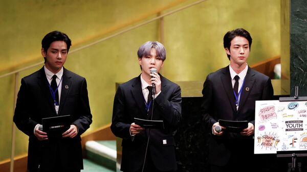 (L to R) V, Suga and Jin of South Korean boy band BTS speak at the SDG Moment event as part of the UN General Assembly 76th session General Debate in UN General Assembly Hall at the United Nations Headquarters, in New York, U.S., September 20, 2021.  - Sputnik International