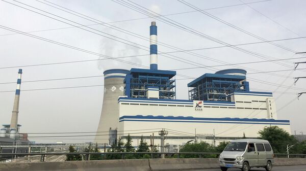 A van travels past a coal-fired power plant of Xuzhou Coal Mining Group in Xuzhou, Jiangsu province, China May 29, 2018 - Sputnik International