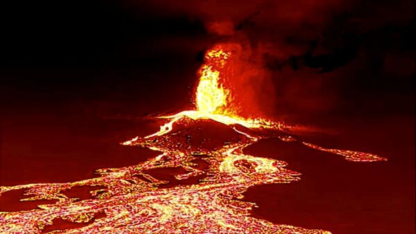 Screen grab from a video taken by a night drone shows the volcano erupting and tongues of lava sweeping over La Palma, Canary Island, on 22 September 2021. - Sputnik International
