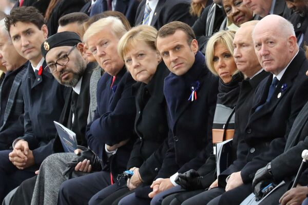 Canadian PM Justin Trudeau,  Moroccan Prince Moulay Hassan, Moroccan King Mohammed VI, US President  Donald Trump, First Lady Melania Trump, German Chancellor Angela Merkel, French President Emmanuel Macron, his wife Brigitte Macron, Russian President Vladimir Putin, and General Peter Cosgrove participating in a WWI commemoration ceremony in Paris. 11 November 2018. - Sputnik International