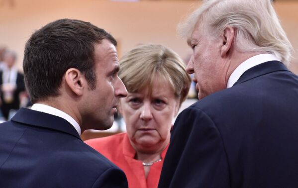 US President Donald Trump, French President Emmanuel Macron, and German Chancellor Angela Merkel chatting during a G20 summit in Hamburg. 7 July 2017. - Sputnik International