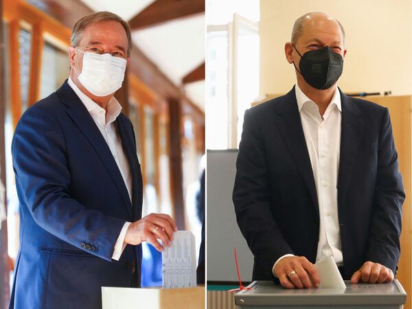 This combination of photos taken on 26 September 2021 shows Germany's conservative Christian Democratic Union CDU leader and candidate for chancellor Armin Laschet casting his vote at a polling station in Aachen, western Germany, during general elections (L), and German Finance Minister, Vice-Chancellor and the Social Democratic SPD Party's candidate for chancellor Olaf Scholz casting his ballot at a polling station in Potsdam, eastern Germany.  - Sputnik International