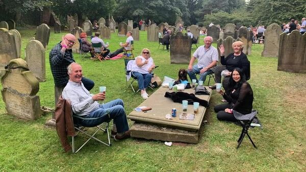 St. Mary's Church beer festival goers enjoy beverage in the church's graveyard. - Sputnik International