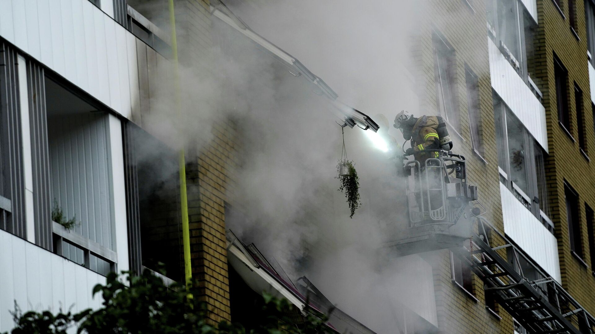 An emergency services crew works to evacuate people and put out fire as smoke comes out of windows after an explosion hit an apartment building in Annedal, central Gothenburg, Sweden September 28, 2021 - Sputnik International, 1920, 28.09.2021