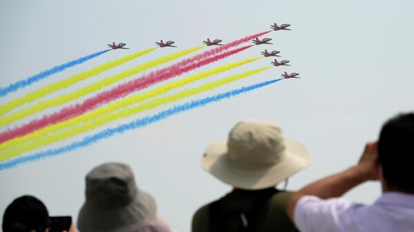 People watch Chinese People's Liberation Army (PLA) Air Force Red Falcon aerobatic team perform at the China International Aviation and Aerospace Exhibition, or Airshow China, in Zhuhai, Guangdong province, China September 28, 2021 - Sputnik International