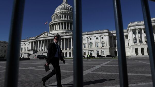 A man walks past the U.S. Capitol building as a government shutdown looms in Washington, U.S., September 30, 2021. REUTERS/Leah Millis - Sputnik International